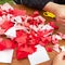 Japanese woman shows a master class on creating origami flowers from paper.