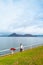 Japanese woman standing by lake Toya shore with Nakajima island