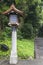 Japanese wood lantern and stone pole in Meiji Jingu Shrine, str