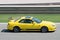 Japanese yellow Honda Prelude car skidding on a circuit