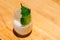 Japanese Yuzu Cocktail with Shiso Leaves Green Perilla in glass on marble top table