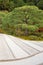 Japanese zen garden meditation stone in lines sand