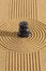 Japanese zen garden with stone in textured sand