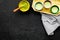 Japanise tea ceremony with matcha tea. Bowl with powder and cups with beverage on tablecloth black background top view