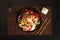 Japchae, Korean glass noodle stir fry. Korean glass japche noodles with stewed chicken with sesame vegetables and sauce on a black