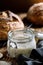 A jar with active rye sourdough for baking bread on a wooden table