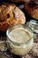 A jar with active rye sourdough for baking bread on a wooden table