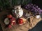 Jar,apples,pomegranate,coffe cup with books and orange on canvas drapery conceptual still-life