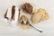 Jar with chocolate paste, spoon with paste on slice of bread, sandwich with paste on table. Top view