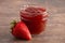 Jar of Classic Strawberry Jam on a Rustic Wooden Table