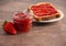 Jar of Classic Strawberry Jam on a Rustic Wooden Table