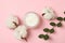 Jar of cosmetic cream, branch and cotton on pink background