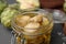 Jar of delicious artichokes pickled in olive oil on table, closeup