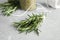 Jar with dried rosemary, twine and fresh twigs