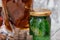 jar of exotic jam made from pine cones and fir needles with burnt oak cubes lying on a wooden stand