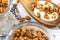 A jar fiiled with granola,wooden spoon whit granola, on white wood table, close-up,selective focus