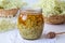 A jar filled with fresh elder flowers and honey, to prepare syrup