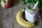 A jar of fruit smoothies with mint leaves, banan, Apple, mint branches on a brown old wooden background.