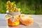 Jar full of delicious fresh honey piece of honeycomb and wild flowers