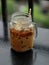 A jar glass with iced coffee served at the balcony