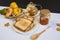 Jar of homemade jam with tea, sandwich and quinces