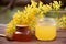 Jar of honey and blooming acacia