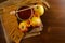 Jar with honey, rye bread, apples, yellow daisy and ears on sacking, wooden table