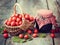 Jar of jam and hawthorn berries in basket on table