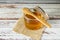 Jar of pure honey from bees with a wooden spoon on a rustic table