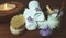 Jar of scrub on the spa table with a set of towels, brush and sea salt