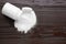 Jar of sweet powdered fructose on black wooden table, top view. Space for text