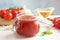 Jar of tasty tomato sauce on wooden table