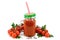 A jar of tomato juice with a lid and a straw. Around there are bunches of bush tomatoes with parsley and allspice