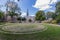 Jardin d`Isabelle with a circular structure formed with bricks on the lawn