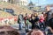 Jared Leto surrounded by a crowd of Ukrainian fans taking pictures near the hill with laid flowers