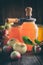 Jars of apple juice, apple fruits and can lid closing machine for canning on kitchen table