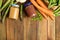 Jars with baby food and fresh vegetables on table, flat lay. Space for text