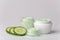 Jars of body cream and cucumber slices