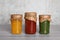 Jars with canned fruit jams on wooden table