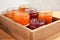 Jars with different sweet jam in wooden crate