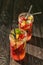 Jars of fresh raspberry mojito on wooden table