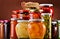 Jars with fruity compotes jams and pickled vegetables