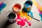 Jars with gouache paints and brushes on colorful paint splashes background AI Generated