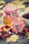 Jars of honey and tea cup. Maple leaves and dog rose berries