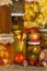 Jars with marinated food and organic raw vegetables. Preserved vegetables on wooden background. Various marinaded food. Life on a