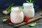 Jars with melted sour milk and natural yoghurt.