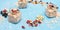 Jars with muesli, berries, nuts and seeds on blue rustic background. Healthy food, Diet, Detox, Clean Eating or Vegetarian