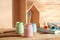 Jars of paints with brush on wooden table, closeup. Interior elements