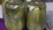 Jars of pickled cucumbers. Stand with the lid down. Pickling cucumbers at home. Vegetable harvest conservation. Close-up shot