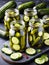 jars with pickled cucumbers on wooden table